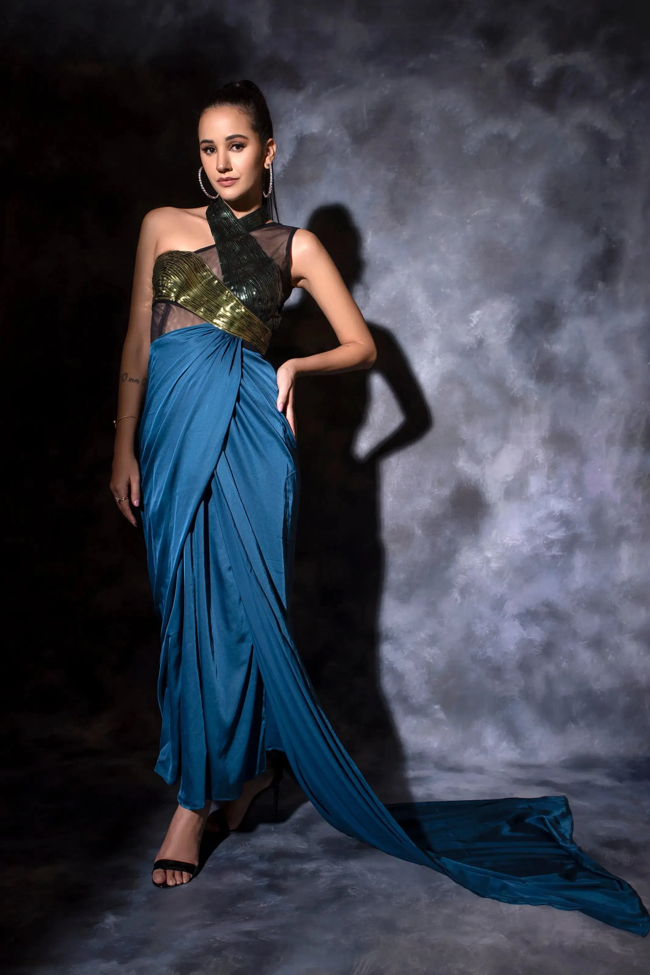 One shoulder drape in teal blue with a metallic molded drape dress